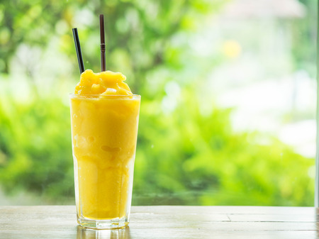 Mango smootie with green backgroundの写真素材