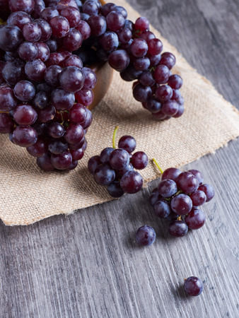 Seedless Grapes on black and wood background ready to serveの写真素材