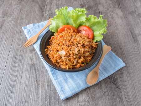 Kimchi fries rice in black and white plate on wood backgroundの写真素材