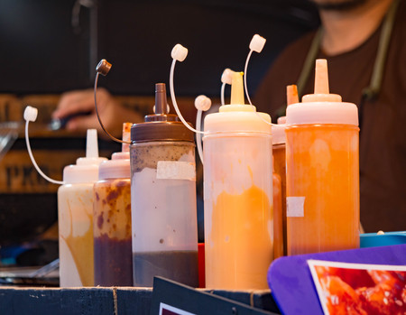 Many plastic sauce bottles in shelt ready to useの写真素材