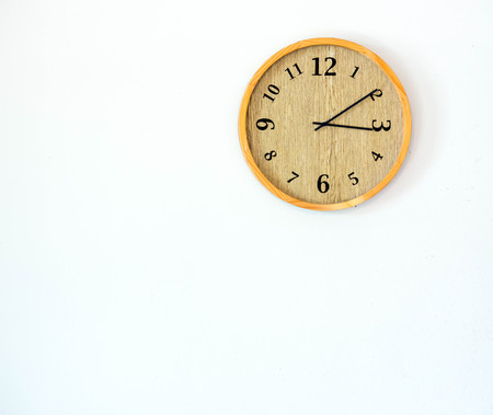 One Wood clock on white wall, free spaceの写真素材