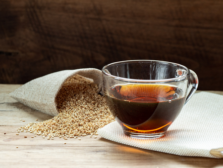 Sesame oil in one gleass on wood table, prepare for cooking concept.の写真素材