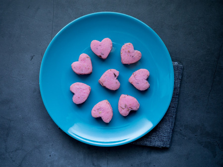Kleeb Lamduan,Thai shortbread cookies heart shape in blue plate on black background for love issue or valentine's day.の写真素材