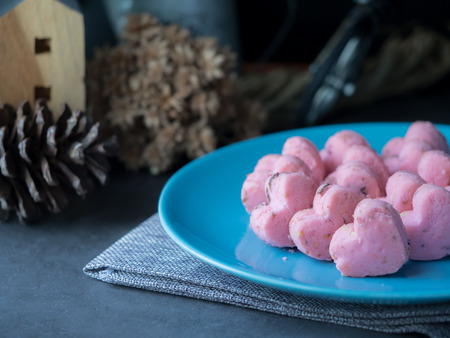 Kleeb Lamduan,Thai shortbread cookies heart shape in blue plate on black background for love issue or valentine's day.の写真素材