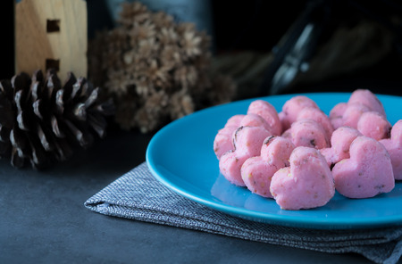 Kleeb Lamduan,Thai shortbread cookies heart shape in blue plate on black background for love issue or valentine's day.の写真素材