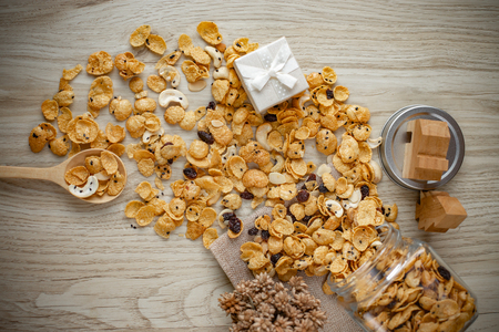 Cornflakes caramel in glass bottle on wood background.の写真素材