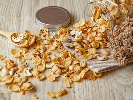 Cornflakes caramel in glass bottle on wood background.の写真素材