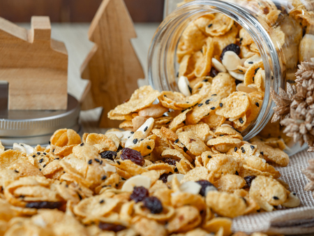 Cornflakes caramel in glass bottle on wood background.の写真素材