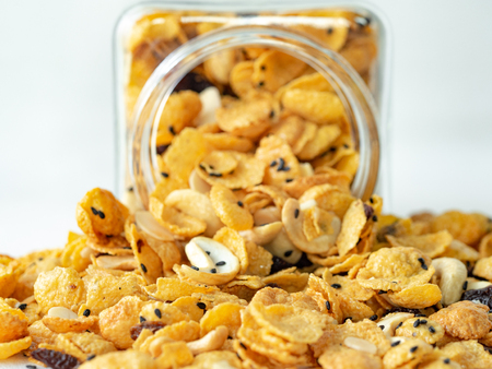 Cornflakes caramel in glass bottle on wood background.