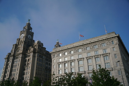 Liverpool, UK-May 24, 2017: Flag of UK and England flew at half-mast on a building at Liverpool waterfrontのeditorial素材