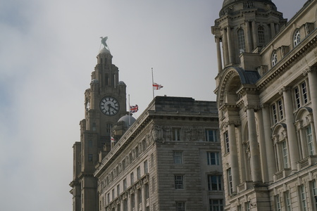 Liverpool, UK-May 24, 2017: Flag of UK and England flew at half-mast on a building at Liverpool waterfrontのeditorial素材