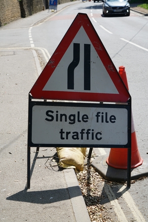 Single file traffic sign in English villageの写真素材