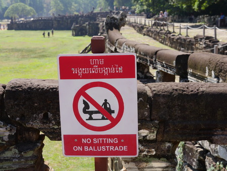 Siem Reap-December 22, 2017: No sitting on balustrade-Notice at Angkor Thomの写真素材