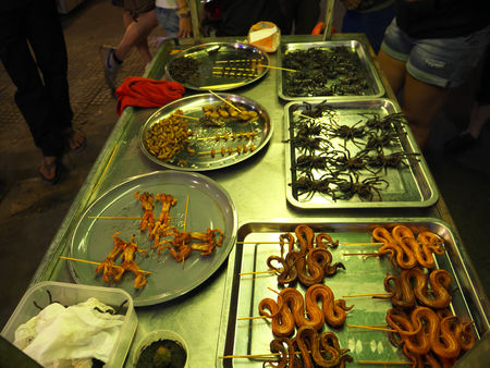 Siem Reap, Cambodia-December 22, 2017: Grilled insects and snakes are sold by a pushcart vendor at Old market in Siem Reap, Cambodia.のeditorial素材