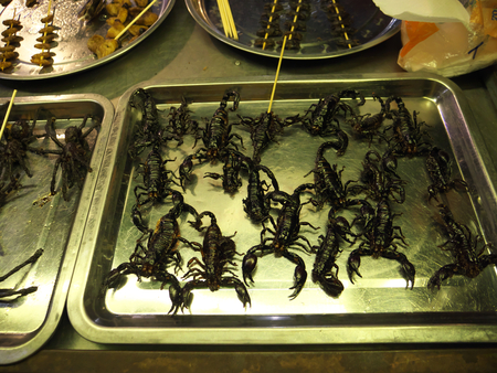 Siem Reap, Cambodia-December 22, 2017: Grilled insects and snakes are sold by a pushcart vendor at Old market in Siem Reap, Cambodia.のeditorial素材