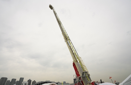 Extended ladder of the fire engine or hook-and-ladder truck. The maximum length of the ladder is 30 m.の写真素材
