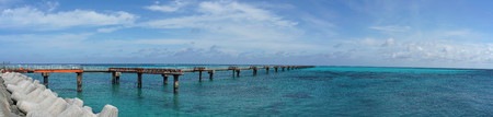 A small pier for boats to dock on a blue water