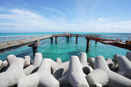 A small pier for boats to dock on a blue waterの写真素材
