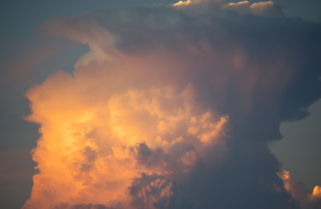 Tokyo, Japan - August 26, 2018: Gigantic cumulonimbus incus or anvil illuminated by the setting sunの写真素材