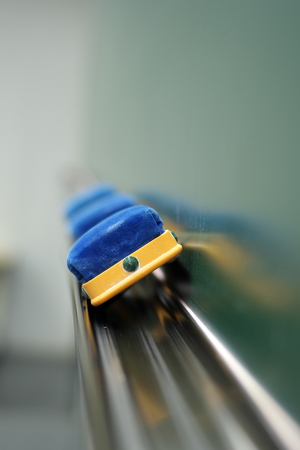 Three erasers and a blackboard in a classroomの写真素材