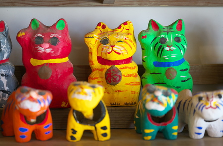Chiba, Japan-February 19, 2019: Papier mache beckoing cat or fortune cat or figure of a cat with one paw raised or maneki n Eko.のeditorial素材