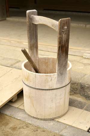 A Japanese pail or a wooden bucket and a ladle or a dipperの写真素材