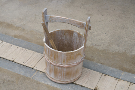 A Japanese pail or a wooden bucket and a ladle or a dipperの写真素材