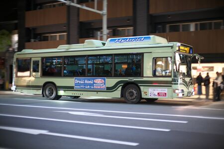 Kyoto,Japan-November 14, 2019: Panning of Kyoto City Bus on Shijo street in Kyotoのeditorial素材