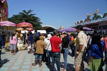 Chachoengsao,Thailand-December 5, 2019: People standing in a queue to whisper their desire into an ear of mouse at Wat Sam an Rattanaramのeditorial素材