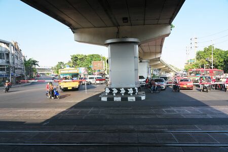 Bangkok,Thailand-December 5, 2019: People waiting for a steam locomotive train to pass at a railroad crossing of Phetchabu ri road and Phiisanulok Road in Bangkok.のeditorial素材