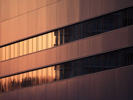 Tokyo,Japan-February 11, 2020: Reflection of Glow of the Sunset on the Window Glass of a Building