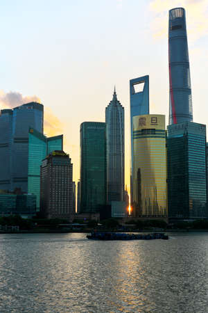 Shanghai,China-September 18, 2019: The sun rises between Pudong New Area buildings in Shanghaiのeditorial素材