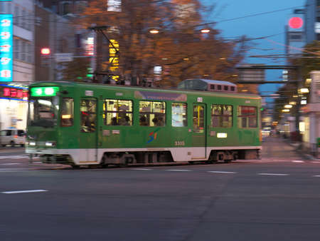 Hokkaido,Japan-November 8, 2020: Panning of a tramcar running Susukino intersection in Sapporo city in the nightのeditorial素材