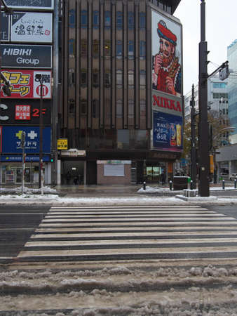 Hokkaido,Japan-November 11, 2020: Snow covering Susukino intersection, the most busy area in Sapporo City, Hokkaidoのeditorial素材
