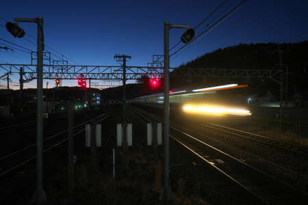 Kyoto,Japan-November 21, 2020: A train passing a station at dusk in Kyoto