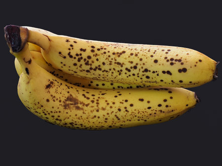 Banana with black spot isolated on blackの写真素材