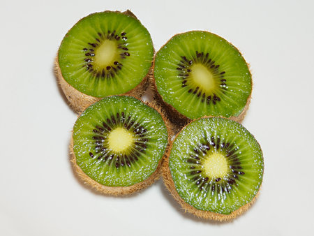 Fresh slices of kiwi on whiteの写真素材
