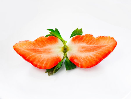 Fresh and juicy sliced strawberry on white backgroundの写真素材