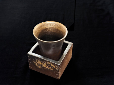 Bizen-yaki or Bizen ware cup and square box on black backgroundの写真素材