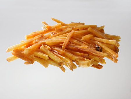 Closeup of Imokenpi, fried sweet potato stick, on white backgroundの写真素材