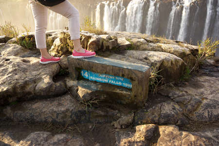 Victoria Falls,Zimbabwe-July 31, 2015: Warning of slippery rocks at Victoria Fallsの写真素材