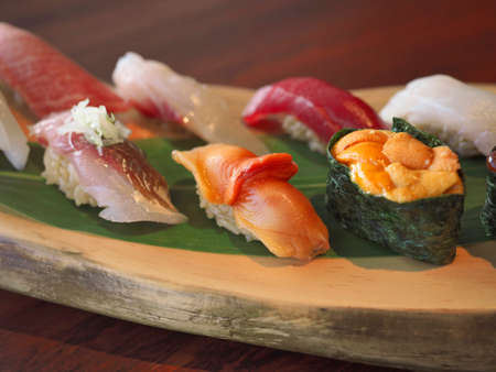 Okinawa,Japan - July 12, 2021: Closeup of hand-formed sushi on a wooden plateの写真素材