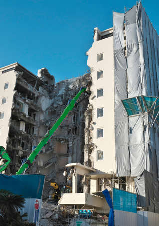 Okinawa,Japan - July 11, 2021: Mechanical destruction of a hotel under blue sky