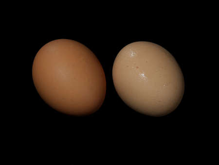 Tokyo,Japan - September 2, 2021: Closeup of raw chicken eggs on black backgroundの写真素材