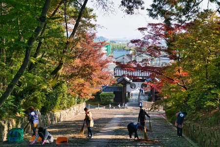 Kyoto,Japan - November 15, 2021: Morning sweeping of stone steps at Komyoji temple, Kyotoのeditorial素材