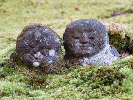 Kyoto,Japan - November 20, 2021: Small jizo or guardian deity of children in a moss-covered garden in Kyoto, Japanのeditorial素材