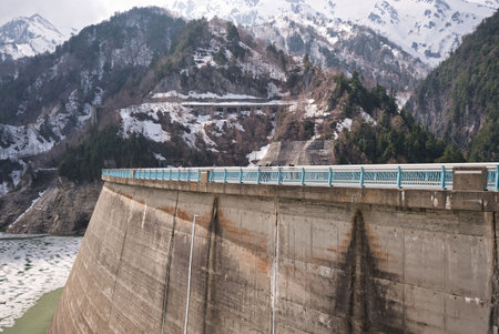 Toyama,Japan - April 23, 2022: A partially ice-covered Kurobe lake and Kurobe Dam in springの写真素材