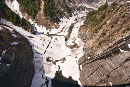 Toyama,Japan - April 23, 2022: A partially ice-covered Kurobe lake and Kurobe Dam in springの写真素材