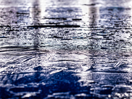 Tokyo, Japan - January 5, 2023: Lights reflecting on the ice in a pondの写真素材