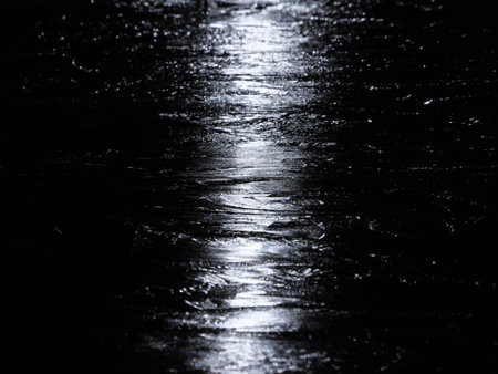 Tokyo, Japan - January 11, 2023: Lights reflecting on the ice in a pondの写真素材